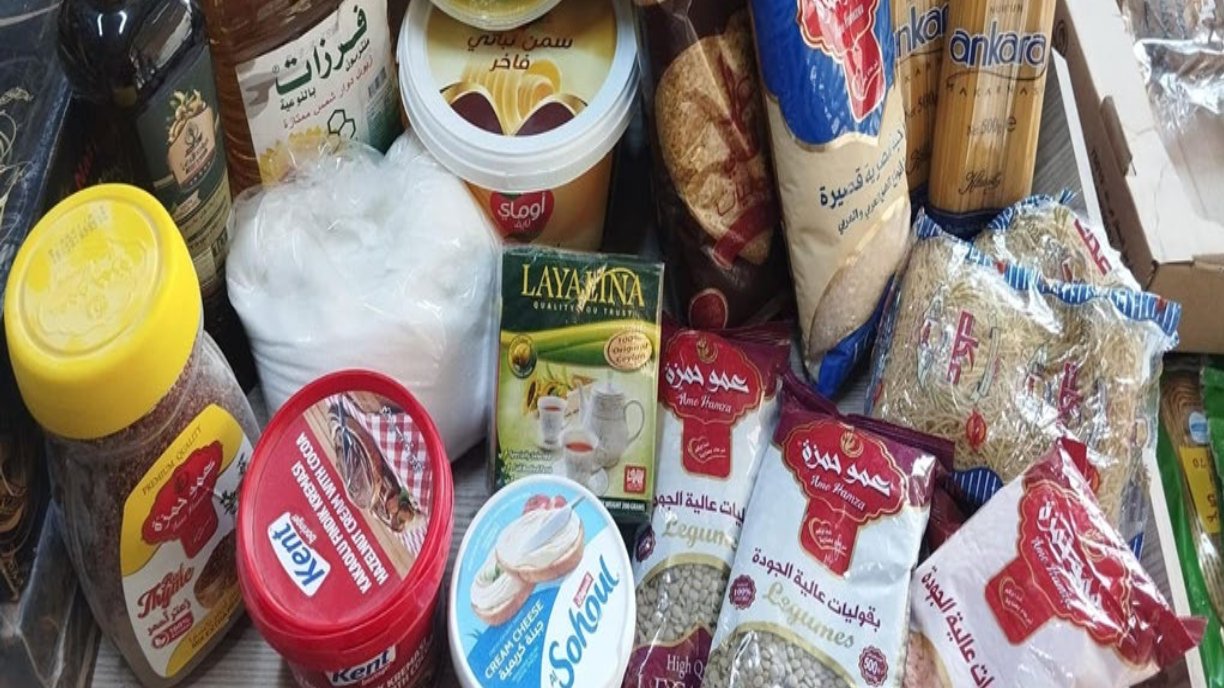 Food parcel items for an orphan family, including rice, oil, lentils, pasta and other kitchen staples
